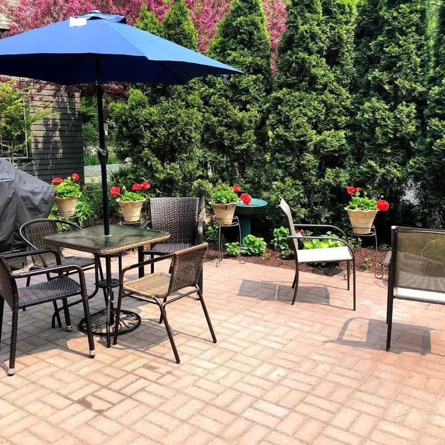 The Cottage features a large outside dining, lounge area surround by lush plantings.